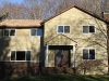 Failing stucco and tudor board in Morris County - after with new brickface facade.